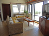 Living room has an open floor plan with door opening to the covered patio.