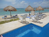 La Joya's lovely white sand beach has lounge chairs and thatched palapas.