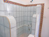 Huge tiled shower in the bathroom.